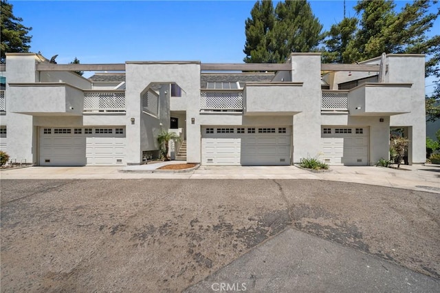 222 N Singingwood St Unit 9, Orange, CA 92869 - view of front facade featuring a balcony, stucco siding, and an attached garage
