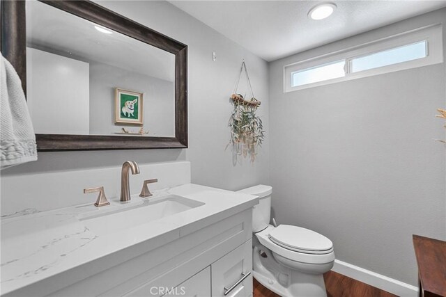 222 N Singingwood St Unit 9, Orange, CA 92869 - half bathroom featuring vanity and wood finished floors