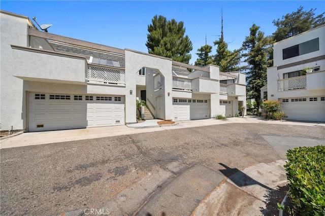 222 N Singingwood St Unit 9, Orange, CA 92869 - view of front of house with stucco siding, a balcony, and stairway