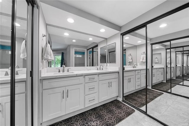 222 N Singingwood St Unit 9, Orange, CA 92869 - bathroom featuring double vanity, recessed lighting, and marble finish flooring