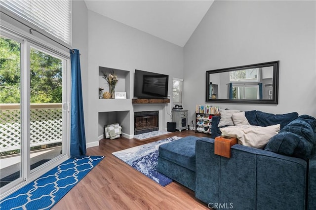 222 N Singingwood St Unit 9, Orange, CA 92869 - living room with high vaulted ceiling, wood finished floors, and a fireplace with flush hearth