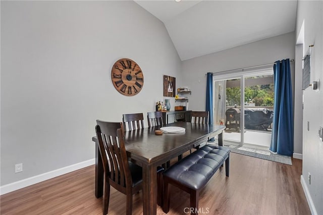 222 N Singingwood St Unit 9, Orange, CA 92869 - dining room with wood finished floors and high vaulted ceiling