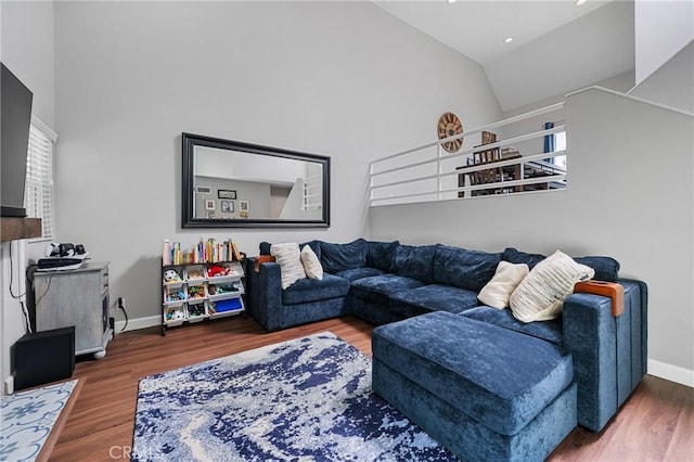 222 N Singingwood St Unit 9, Orange, CA 92869 - living area with high vaulted ceiling, healthy amount of natural light, wood finished floors, and recessed lighting