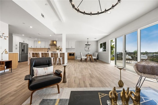 235 Via Ballena, San Clemente, CA 92672 - living area with a chandelier, light wood finished floors, recessed lighting, and a high ceiling