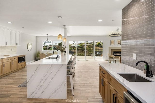 235 Via Ballena, San Clemente, CA 92672 - kitchen with a chandelier, light wood finished floors, recessed lighting, and decorative backsplash