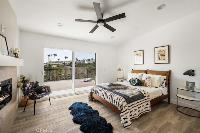235 Via Ballena, San Clemente, CA 92672 - bedroom with access to outside, wood finished floors, a tiled fireplace, recessed lighting, and a ceiling fan