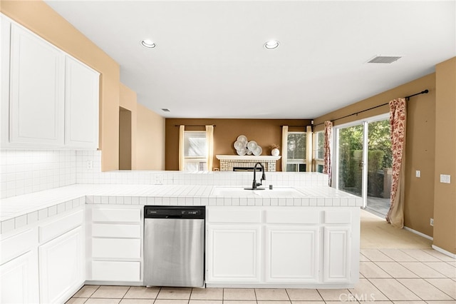 45422 Camino Monzon, Temecula, CA 92592 - kitchen featuring stainless steel dishwasher, tile countertops, white cabinetry, tasteful backsplash, and a peninsula