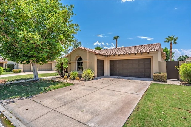 56720 Jack Nicklaus Blvd, La Quinta, CA 92253 - mediterranean / spanish house featuring an attached garage, stucco siding, a tile roof, concrete driveway, and a front yard