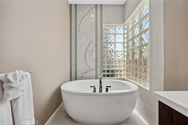 56720 Jack Nicklaus Blvd, La Quinta, CA 92253 - bathroom with a soaking tub, vanity, and a textured wall