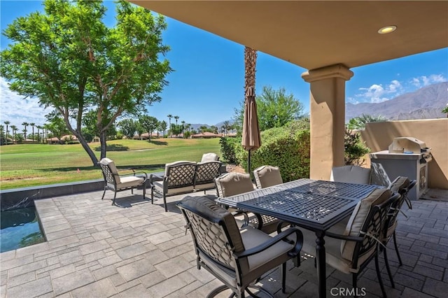 56720 Jack Nicklaus Blvd, La Quinta, CA 92253 - view of patio with a mountain view, an outdoor kitchen, an outdoor hangout area, and outdoor dining space