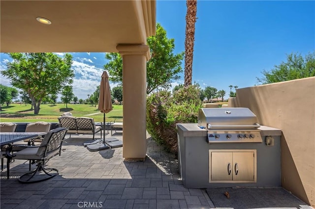 56720 Jack Nicklaus Blvd, La Quinta, CA 92253 - view of patio with outdoor dining space and an outdoor kitchen