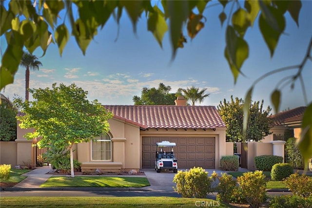 56720 Jack Nicklaus Blvd, La Quinta, CA 92253 - mediterranean / spanish house with a tiled roof, an attached garage, stucco siding, driveway, and a chimney