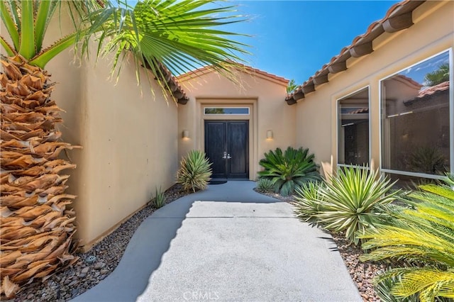 56720 Jack Nicklaus Blvd, La Quinta, CA 92253 - property entrance with stucco siding and a tile roof