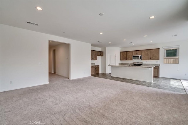 29601 Tulipwood St, Menifee, CA 92584 - unfurnished living room featuring light colored carpet and recessed lighting