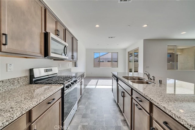 29601 Tulipwood St, Menifee, CA 92584 - kitchen with appliances with stainless steel finishes, light stone countertops, and recessed lighting