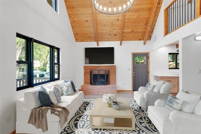 33198 Arrowbear Dr, Running Springs, CA 92382 - living area featuring a wooden ceiling with exposed beams, high vaulted ceiling, a chandelier, a fireplace, and wood finished floors
