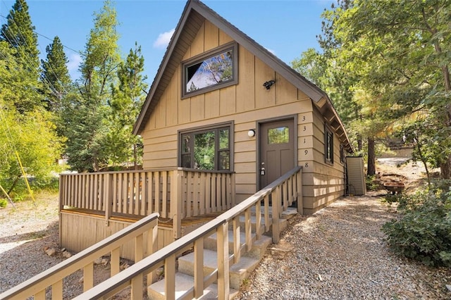 33198 Arrowbear Dr, Running Springs, CA 92382 - rustic home with board and batten siding and a deck