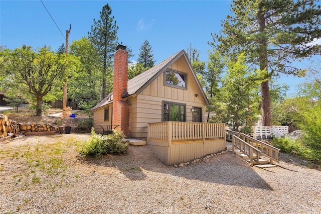 33198 Arrowbear Dr, Running Springs, CA 92382 - view of front of home with a chimney, a wooden deck, and board and batten siding