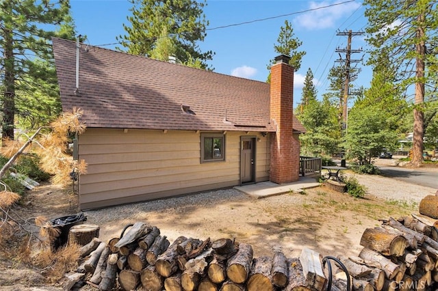 33198 Arrowbear Dr, Running Springs, CA 92382 - rear view of house with a chimney and a shingled roof