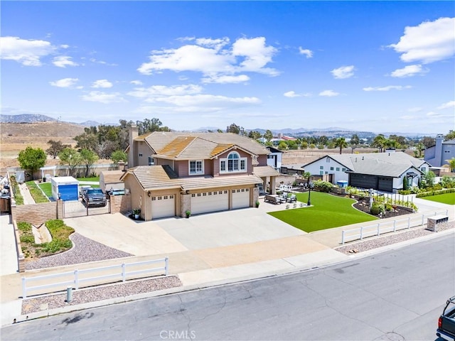 2571 Stetson Dr, Norco, CA 92860 - traditional-style house with an attached garage, a tiled roof, a mountain view, concrete driveway, and a residential view