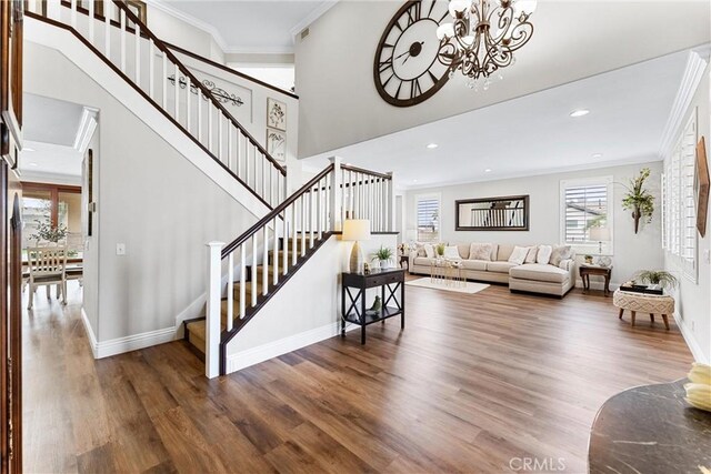 2571 Stetson Dr, Norco, CA 92860 - living room featuring stairs, ornamental molding, wood finished floors, a chandelier, and recessed lighting