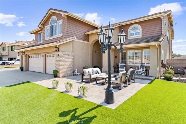 2571 Stetson Dr, Norco, CA 92860 - view of front of property featuring a garage, driveway, stucco siding, a front yard, and an outdoor living space