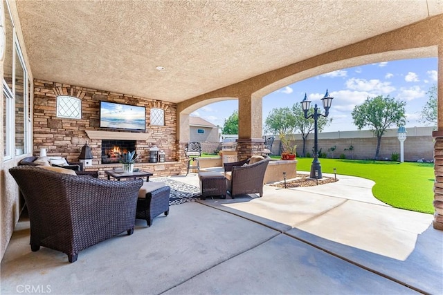2571 Stetson Dr, Norco, CA 92860 - fenced backyard with a patio, an outdoor living space with a fireplace, and exterior kitchen