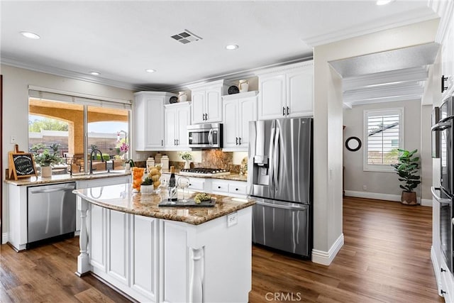 2571 Stetson Dr, Norco, CA 92860 - kitchen featuring stainless steel appliances, ornamental molding, white cabinetry, light stone countertops, and dark wood-type flooring