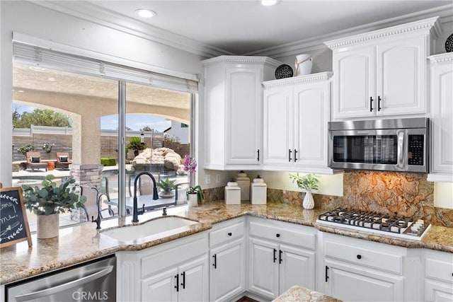 2571 Stetson Dr, Norco, CA 92860 - kitchen with appliances with stainless steel finishes, white cabinets, light stone countertops, ornamental molding, and recessed lighting