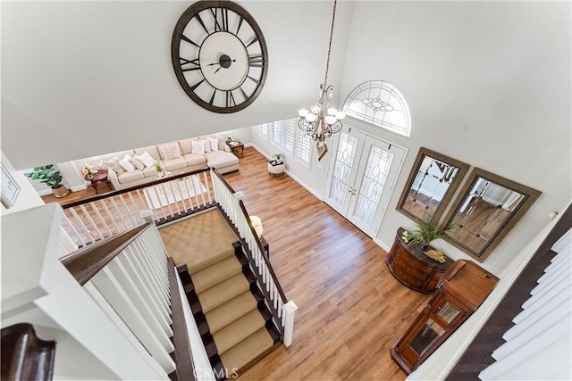 2571 Stetson Dr, Norco, CA 92860 - staircase with a towering ceiling, wood finished floors, and a chandelier
