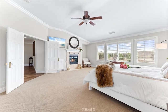 2571 Stetson Dr, Norco, CA 92860 - carpeted bedroom featuring a fireplace with flush hearth, ornamental molding, vaulted ceiling, and ceiling fan
