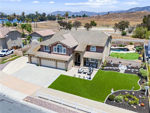 2571 Stetson Dr, Norco, CA 92860 - view of front of house featuring a tile roof, concrete driveway, stucco siding, and a mountain view
