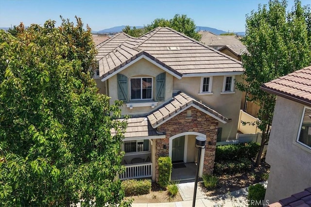 29767 Ascella Ln, Murrieta, CA 92563 - view of front of home featuring stone siding, a tile roof, stucco siding, and a mountain view