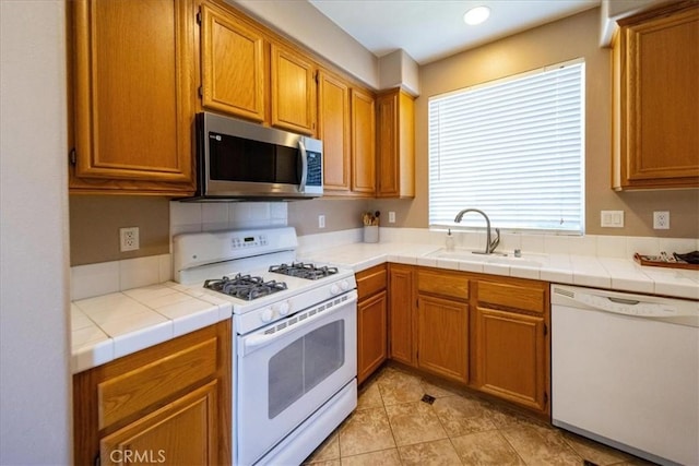 29767 Ascella Ln, Murrieta, CA 92563 - kitchen featuring white appliances, brown cabinets, light tile patterned floors, and recessed lighting