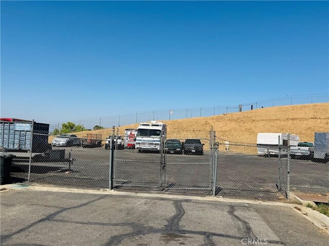 2851 S La Cadena Dr Unit 125, Colton, CA 92324 - view of asphalt road with a gate