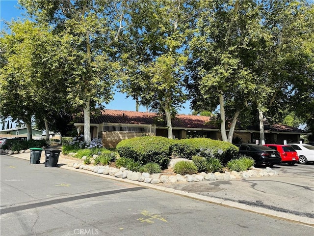 2851 S La Cadena Dr Unit 125, Colton, CA 92324 - view of property hidden behind natural elements with a tile roof