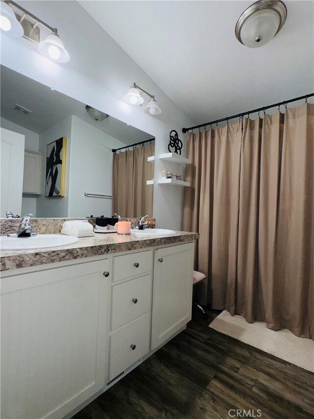 2851 S La Cadena Dr Unit 125, Colton, CA 92324 - full bathroom with wood finished floors, double vanity, and curtained shower