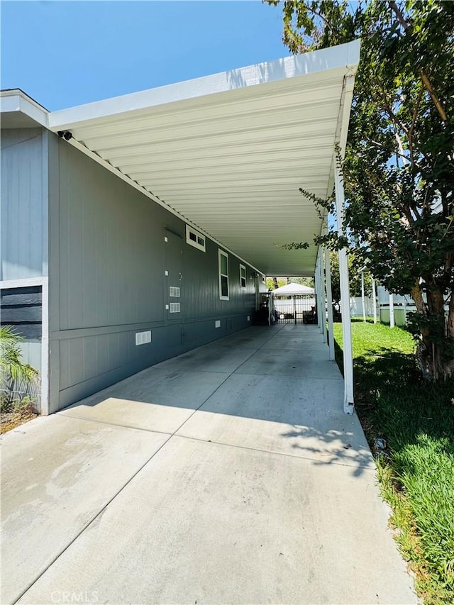2851 S La Cadena Dr Unit 125, Colton, CA 92324 - view of parking featuring a carport and driveway