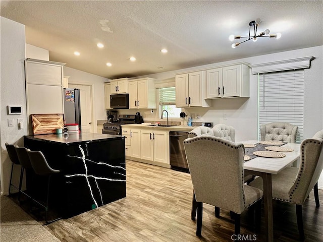 2851 S La Cadena Dr Unit 125, Colton, CA 92324 - kitchen with stainless steel appliances, light wood finished floors, recessed lighting, white cabinets, and a textured ceiling