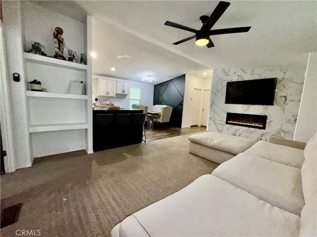 2851 S La Cadena Dr Unit 125, Colton, CA 92324 - carpeted living area with a fireplace, ceiling fan, and built in features