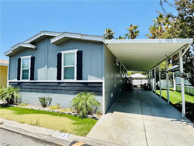 2851 S La Cadena Dr Unit 125, Colton, CA 92324 - manufactured / mobile home featuring driveway, crawl space, and an attached carport