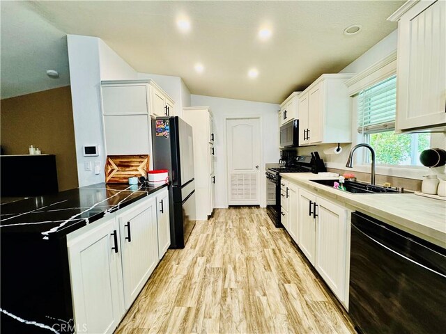 2851 S La Cadena Dr Unit 125, Colton, CA 92324 - kitchen featuring black appliances, white cabinets, and light wood-style flooring