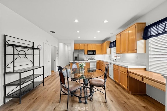 28253 Harmony Ln, Menifee, CA 92584 - dining room with light wood finished floors and recessed lighting