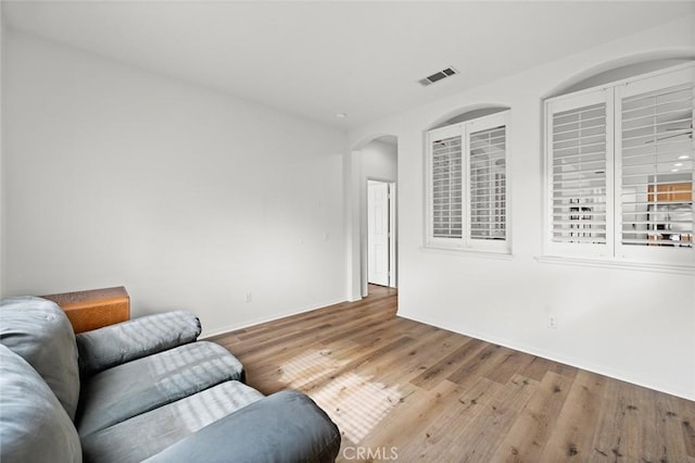 28253 Harmony Ln, Menifee, CA 92584 - living area featuring arched walkways and wood finished floors