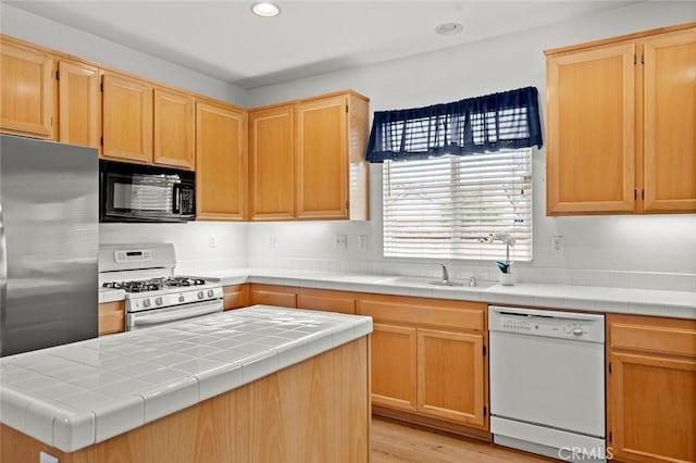 28253 Harmony Ln, Menifee, CA 92584 - kitchen with white appliances, light brown cabinets, a kitchen island, recessed lighting, and light wood-style flooring