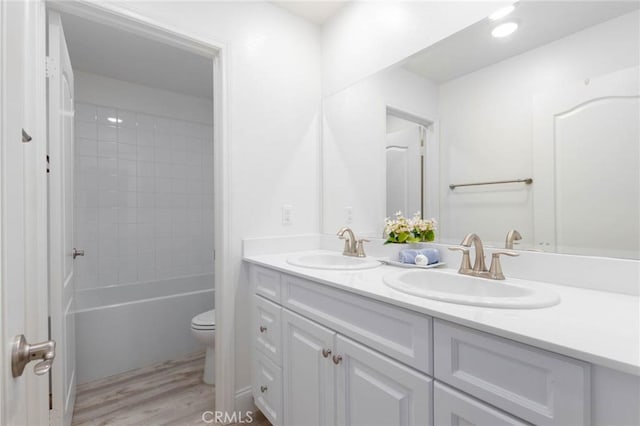 4062 Tamarind Rdg, Lake Elsinore, CA 92530 - bathroom featuring double vanity, wood finished floors, and tub / shower combination