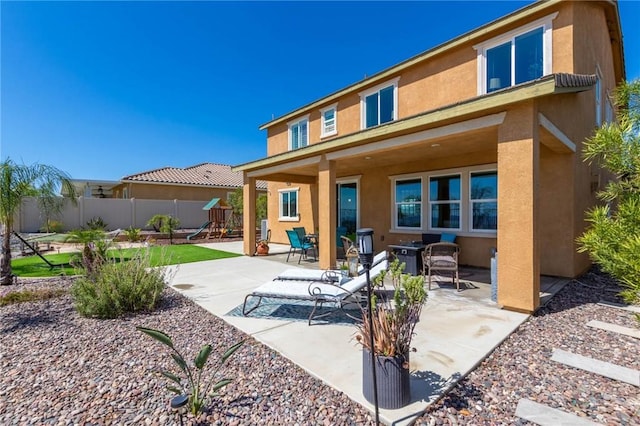 4062 Tamarind Rdg, Lake Elsinore, CA 92530 - back of house featuring stucco siding, a playground, and a patio