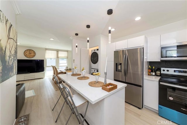 645 N Gramercy Pl, Los Angeles, CA 90004 - kitchen featuring stainless steel appliances, white cabinetry, light wood-style flooring, light countertops, and recessed lighting