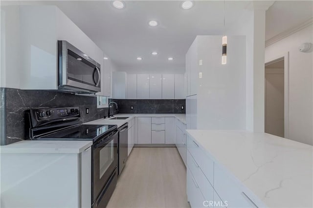 645 N Gramercy Pl, Los Angeles, CA 90004 - kitchen featuring stainless steel appliances, modern cabinets, white cabinets, light stone counters, and recessed lighting