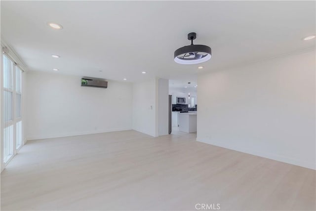 645 N Gramercy Pl, Los Angeles, CA 90004 - unfurnished room featuring recessed lighting, light wood-style floors, ceiling fan, and a wall mounted air conditioner